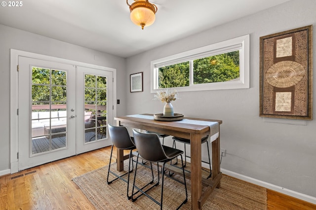 7750 SW 4th Ave, Portland, OR 97219 - dining area featuring french doors, baseboards, and light wood-type flooring