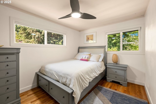 7750 SW 4th Ave, Portland, OR 97219 - bedroom featuring multiple windows, baseboards, and wood finished floors
