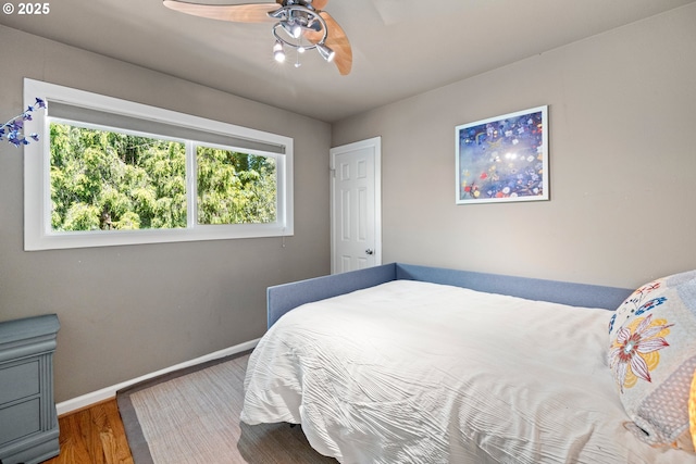 7750 SW 4th Ave, Portland, OR 97219 - bedroom with wood finished floors, baseboards, and a ceiling fan
