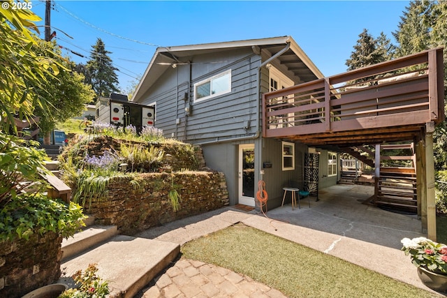 7750 SW 4th Ave, Portland, OR 97219 - rear view of house with a deck, stairway, and a patio area