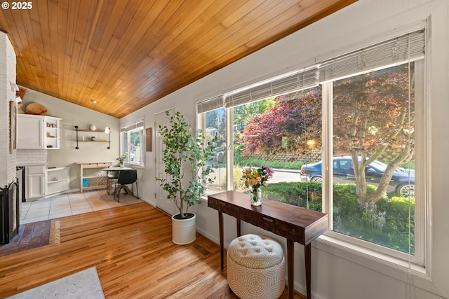 7750 SW 4th Ave, Portland, OR 97219 - living room featuring lofted ceiling, wood ceiling, light wood-style floors, and a fireplace