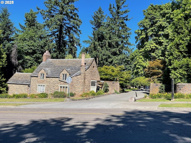 7750 SW 4th Ave, Portland, OR 97219 - view of front of home with a chimney and stone siding