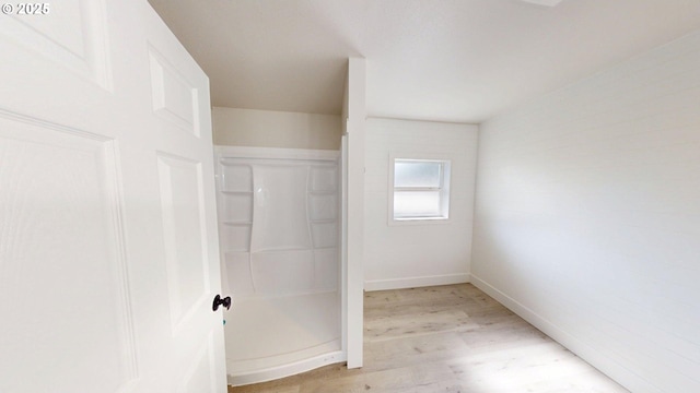 29700 Park Dr, Gold Beach, OR 97444 - full bathroom with a stall shower, wood finished floors, and baseboards
