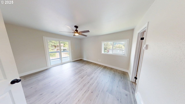 29700 Park Dr, Gold Beach, OR 97444 - unfurnished room with healthy amount of natural light, a ceiling fan, light wood finished floors, and baseboards