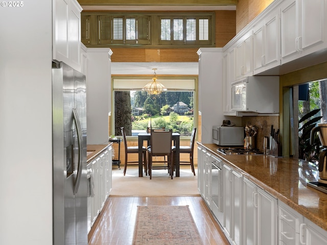6600 SW Montgomery Way, Wilsonville, OR 97070 - kitchen featuring stainless steel refrigerator with ice dispenser, white cabinets, a chandelier, light wood-style floors, and white microwave
