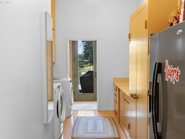 6600 SW Montgomery Way, Wilsonville, OR 97070 - laundry area featuring washer and dryer, light wood-type flooring, and cabinet space