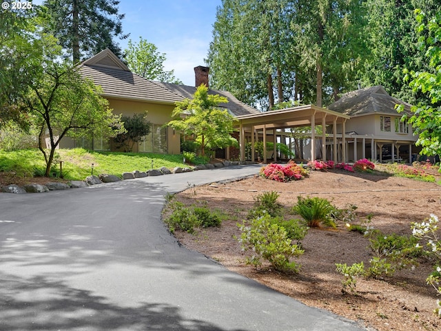 6600 SW Montgomery Way, Wilsonville, OR 97070 - view of front of home featuring a chimney, curved driveway, stucco siding, and a tile roof