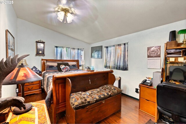 bedroom with baseboards, wood finished floors, and lofted ceiling