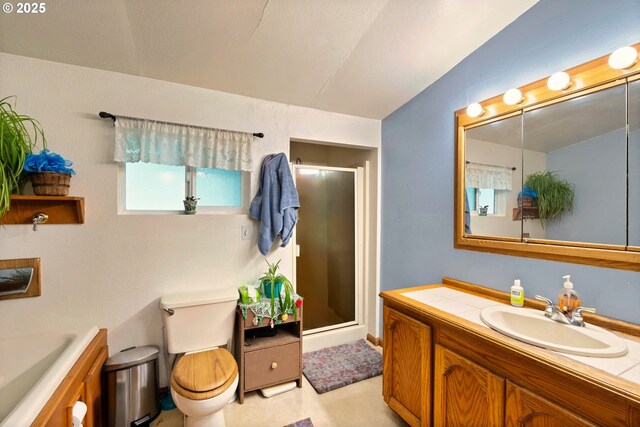 full bath with vanity, toilet, and a stall shower