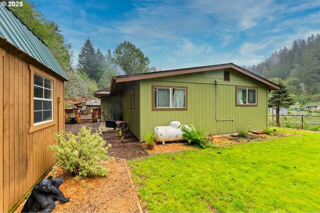 view of home's exterior featuring fence and a yard