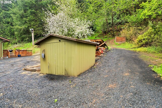 view of shed with a forest view