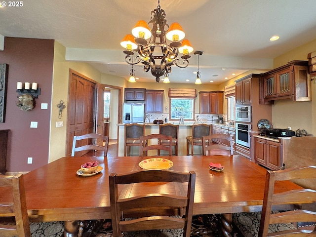 dining room with recessed lighting and a notable chandelier