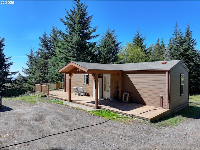 back of house featuring a wooden deck
