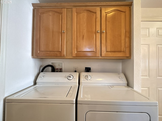 washroom with independent washer and dryer and cabinet space