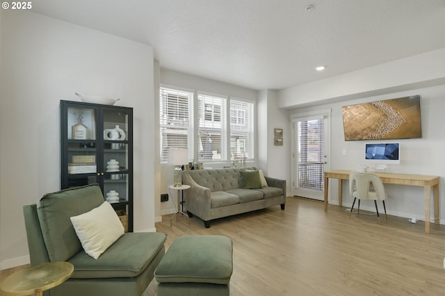 sitting room with recessed lighting, light wood-style flooring, and baseboards