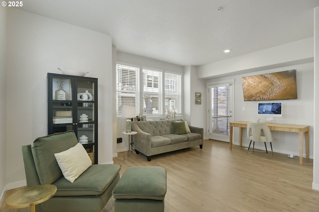 sitting room with light wood-style flooring, baseboards, and recessed lighting