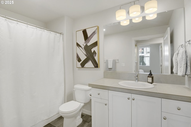 bathroom featuring toilet and vanity