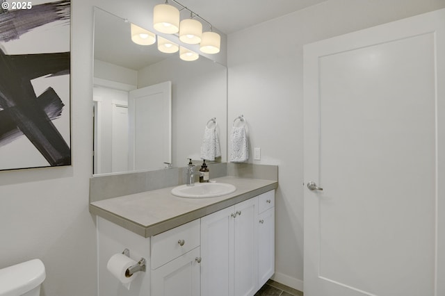 half bathroom with toilet and vanity