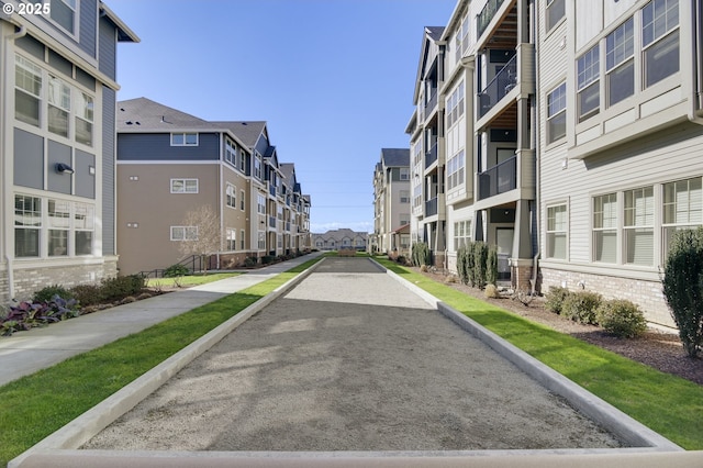 view of street with a residential view, curbs, and sidewalks