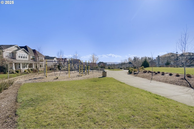 surrounding community featuring playground community, a yard, and a residential view