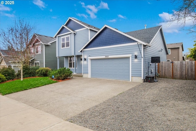 view of front of home with driveway, a front lawn, a garage, and fence