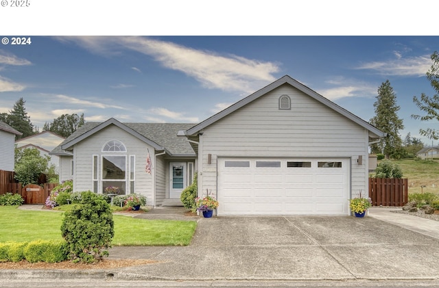 single story home with a front yard and a garage