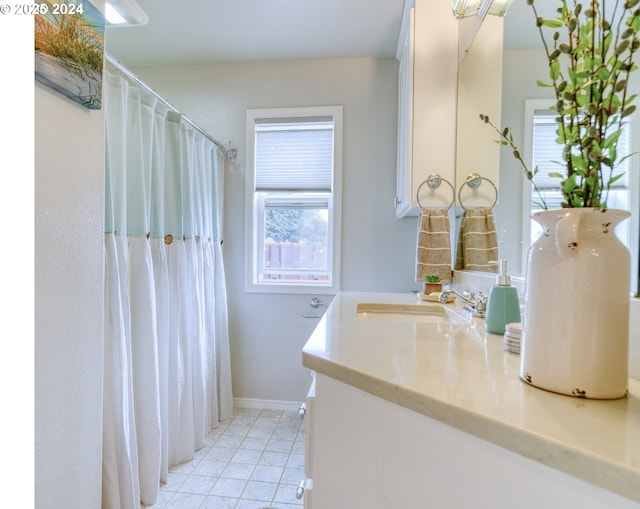 bathroom with tile patterned floors and vanity