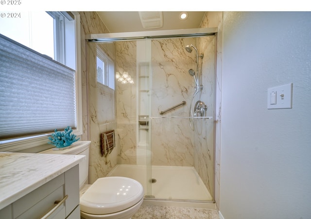 bathroom featuring a shower with shower door, toilet, and vanity