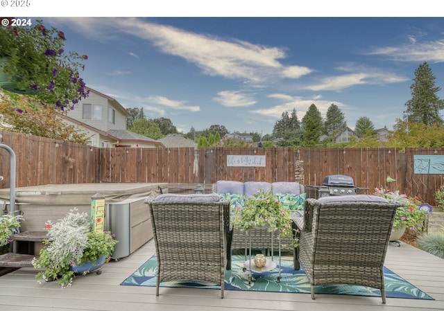 wooden terrace with an outdoor living space, a hot tub, and area for grilling