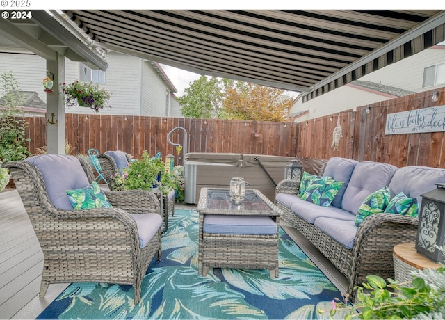 view of patio featuring a hot tub and an outdoor living space