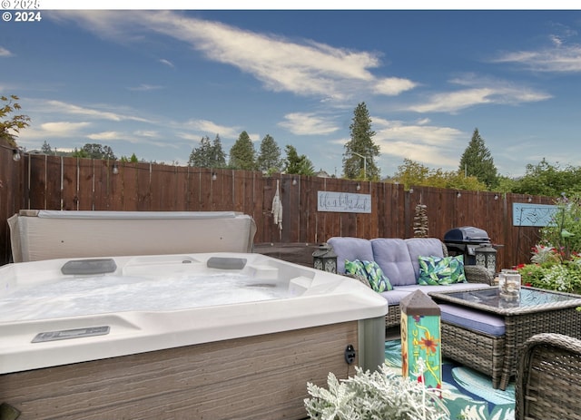 wooden deck with a grill, a hot tub, and an outdoor hangout area