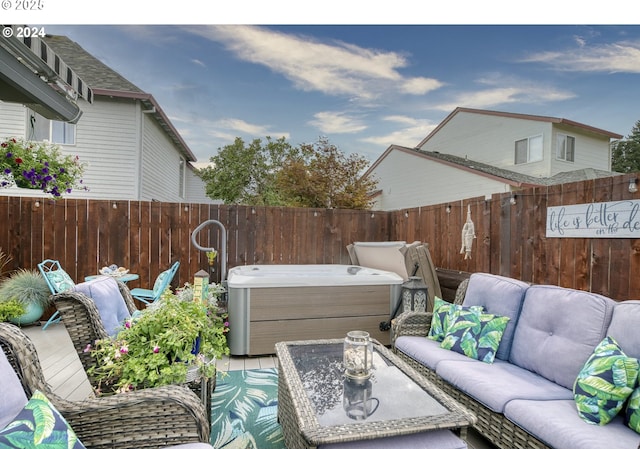 view of patio / terrace with an outdoor living space and a hot tub