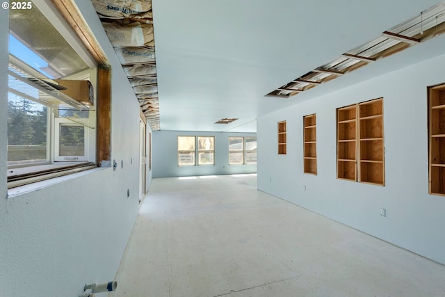 hall with concrete flooring