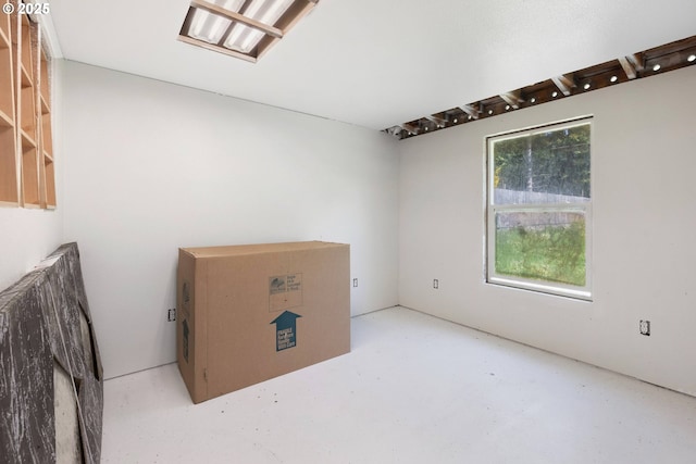unfurnished room with concrete flooring