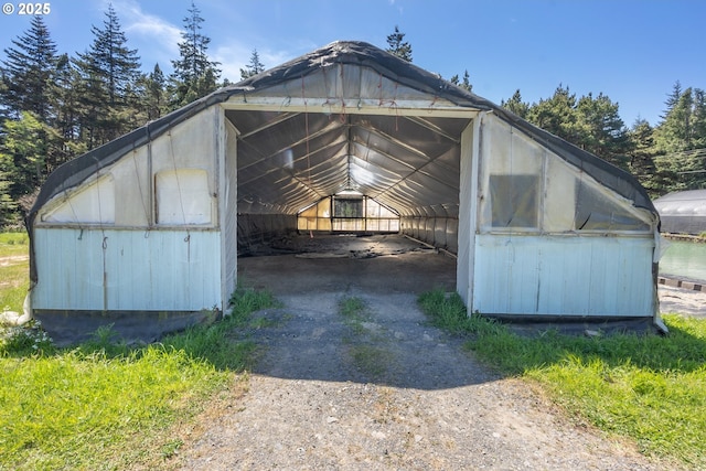 view of outbuilding featuring a detached carport and driveway