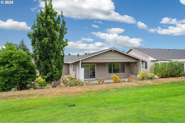 single story home featuring a front lawn and board and batten siding