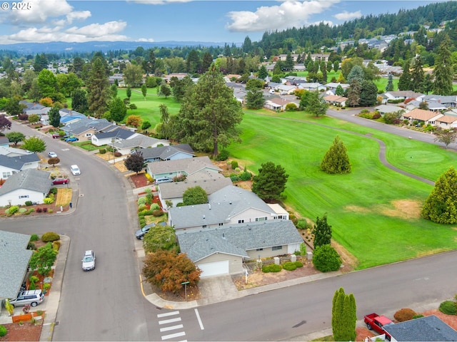 birds eye view of property featuring view of golf course and a residential view