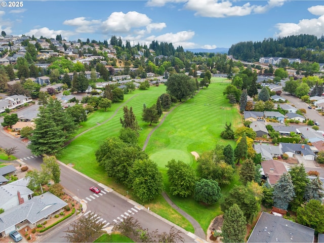 birds eye view of property with view of golf course and a residential view