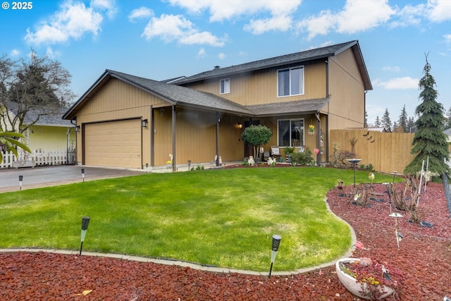 view of front of house featuring a front yard, driveway, fence, and a garage