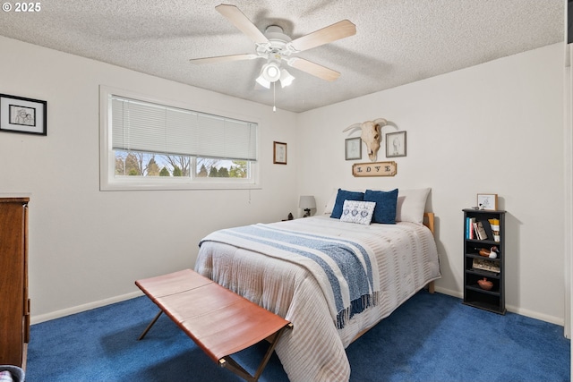 carpeted bedroom with a textured ceiling, baseboards, and a ceiling fan