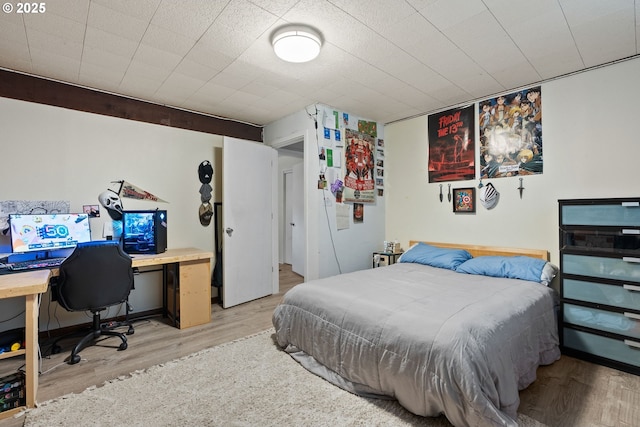 bedroom featuring wood finished floors and baseboards