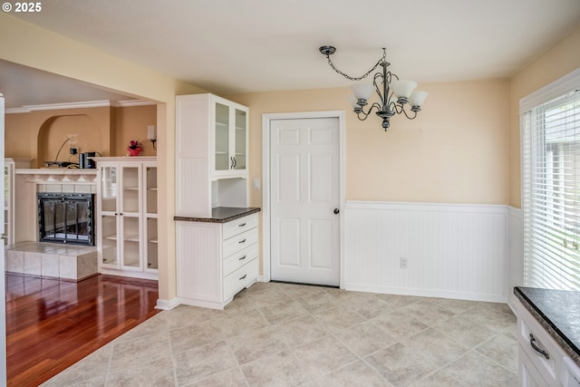821 13th Ave, Seaside, OR 97138 - unfurnished dining area featuring a wainscoted wall, a chandelier, a fireplace, and wine cooler