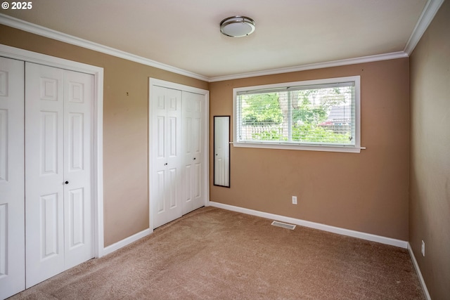 821 13th Ave, Seaside, OR 97138 - unfurnished bedroom featuring carpet flooring, multiple closets, and ornamental molding