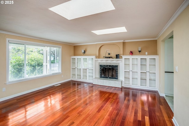 821 13th Ave, Seaside, OR 97138 - unfurnished living room with a skylight, wood finished floors, ornamental molding, and a fireplace