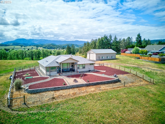 910 Swallow Ave, Sutherlin, OR 97479 - rear view of house with a fenced backyard, a patio, an outdoor structure, and a mountain view