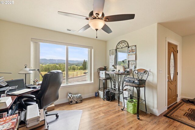 910 Swallow Ave, Sutherlin, OR 97479 - office featuring a ceiling fan, baseboards, wood finished floors, and a mountain view