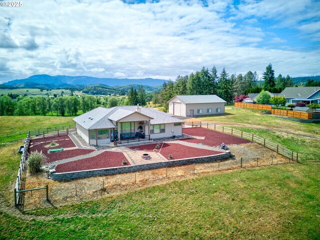 910 Swallow Ave, Sutherlin, OR 97479 - back of house with a patio area, a mountain view, and an outdoor structure
