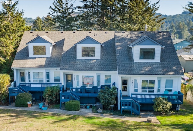 3979 NE Johns Ave, Neotsu, OR 97364 - view of front of property with stairs, a shingled roof, a deck, and a front lawn
