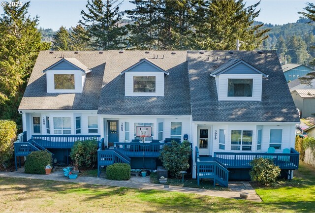 3979 NE Johns Ave, Neotsu, OR 97364 - view of front of property with stairs, a shingled roof, a deck, and a front lawn