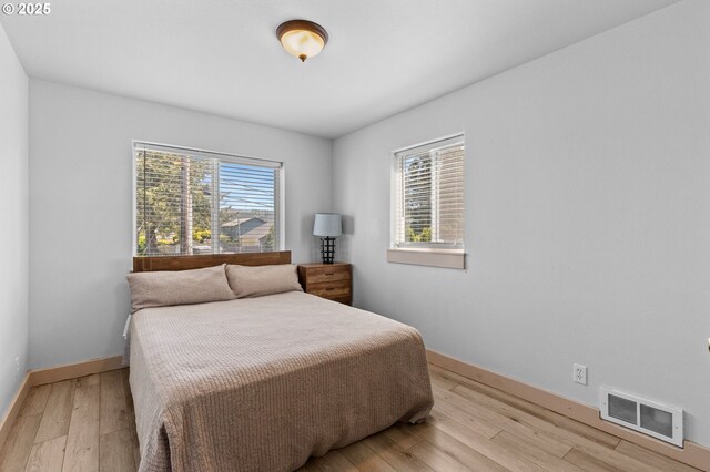 3979 NE Johns Ave, Neotsu, OR 97364 - bedroom featuring baseboards and light wood-style flooring